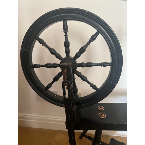 48 - A late 19thC ebonised spinning wheel. 136cm h.