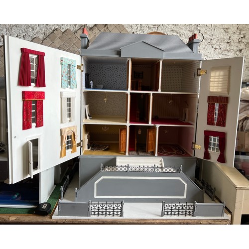 1109 - A large modern dolls house and extensive contents. 112cm h x 98cm w x 78 d.