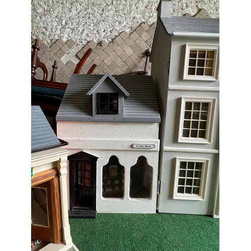 1113 - A modern dolls house, 61cm w x 83cm h x 31cm w together with bakers shop, music room, shop with acco... 