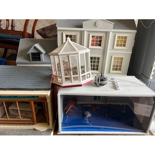 1113 - A modern dolls house, 61cm w x 83cm h x 31cm w together with bakers shop, music room, shop with acco... 