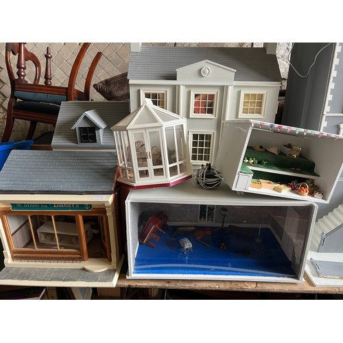 1113 - A modern dolls house, 61cm w x 83cm h x 31cm w together with bakers shop, music room, shop with acco... 