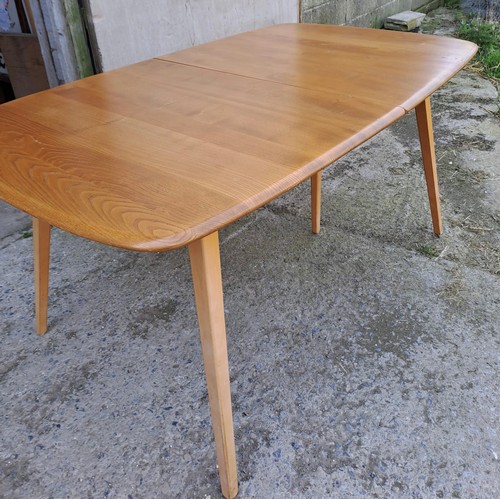 52 - A mid 20thC Ercol extending dining table. Closed 82cm h x 152cm l x 91cm w, fully open 223cm l.