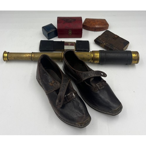 1360 - A miscellany to include a pair of 19thC child’s leather and wooden clogs, a brass and leather covere... 