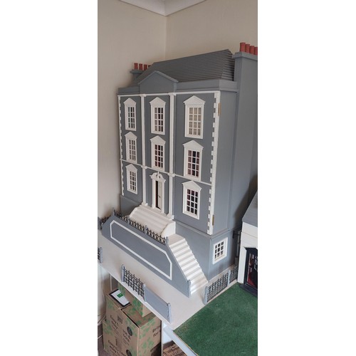 1109 - A large modern dolls house and extensive contents. 112cm h x 98cm w x 78 d.