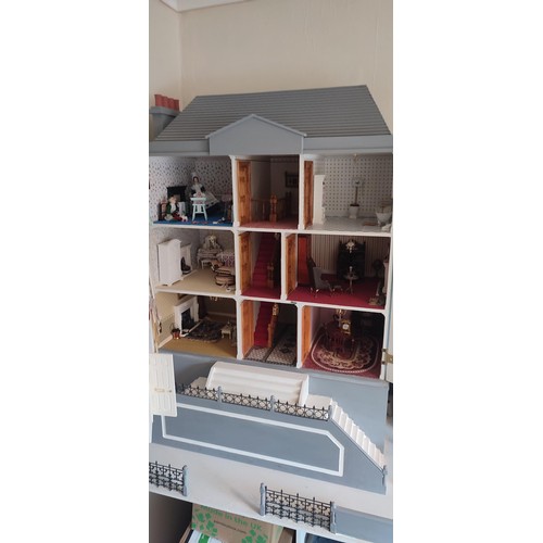 1109 - A large modern dolls house and extensive contents. 112cm h x 98cm w x 78 d.