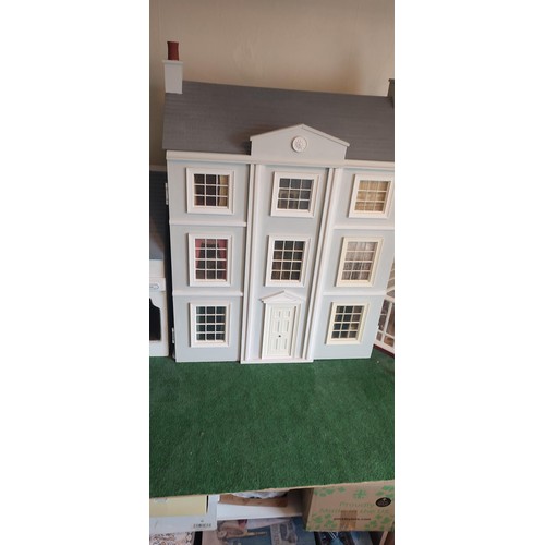 1109 - A large modern dolls house and extensive contents. 112cm h x 98cm w x 78 d.