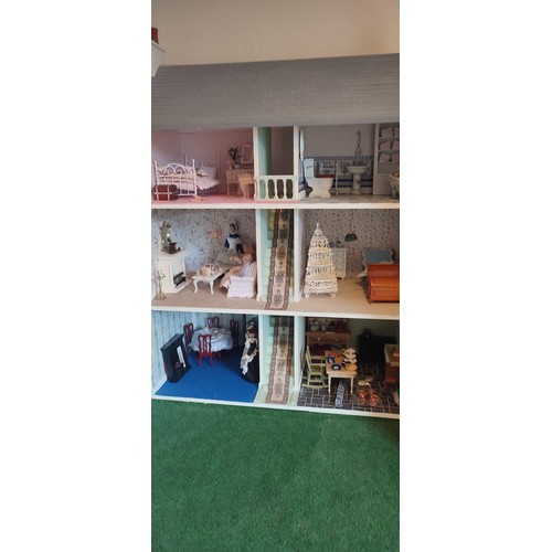 1109 - A large modern dolls house and extensive contents. 112cm h x 98cm w x 78 d.