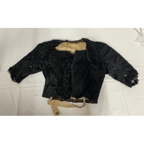 742 - Two Victorian items of clothing to include a child’s dress in brown with black velvet trim, lace sle... 