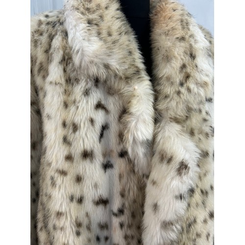 734 - An Astraka of London faux fur leopard skin coat. Approx. 122cm from top of back collar to hem.  Stat... 