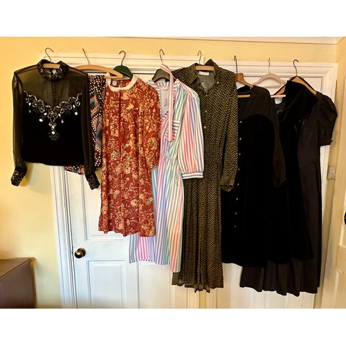 732 - A large quantity of vintage clothing to include a 1980's black cotton Laura Ashley dress, a black ve... 