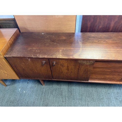 9 - A mid 20thC long sideboard, three cupboards and three drawers. 203cm l x 43cm d x 77cm h.