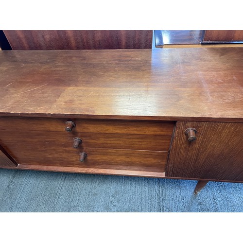 9 - A mid 20thC long sideboard, three cupboards and three drawers. 203cm l x 43cm d x 77cm h.