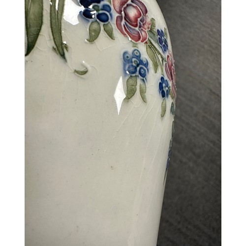 204 - A William Moorcroft for Macintyre Burslem vase with floral garlands and rosettes. 19cms. Stamped to ... 