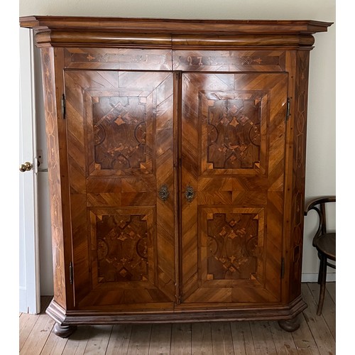 126 - An 18thC Austrian inlaid two door wardrobe on bun feet. Dated 1727 to the top. 202cm h x 57cm d x 17... 