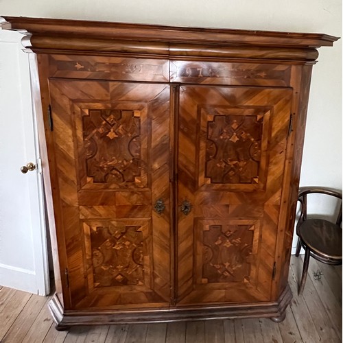 126 - An 18thC Austrian inlaid two door wardrobe on bun feet. Dated 1727 to the top. 202cm h x 57cm d x 17... 