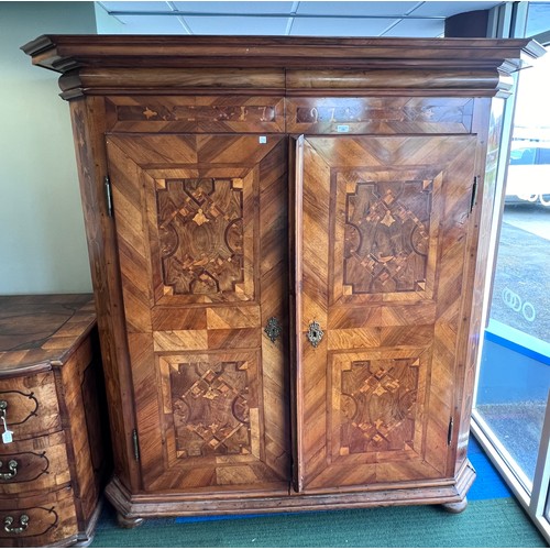 126 - An 18thC Austrian inlaid two door wardrobe on bun feet. Dated 1727 to the top. 202cm h x 57cm d x 17... 