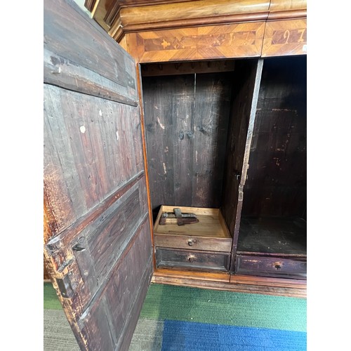 126 - An 18thC Austrian inlaid two door wardrobe on bun feet. Dated 1727 to the top. 202cm h x 57cm d x 17... 