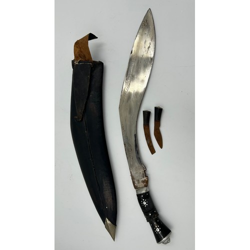 1037 - Kukri with curved 39cm blade engraved India, in leather covered scabbard with two skinning knives.