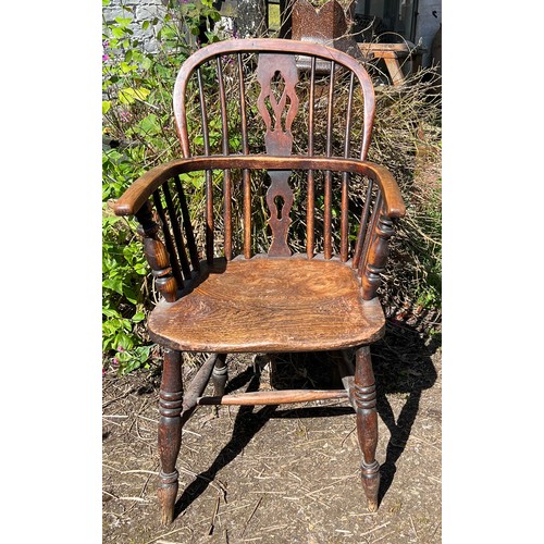 131 - A 19thC ash and elm Windsor armchair. Height to back 96cm.