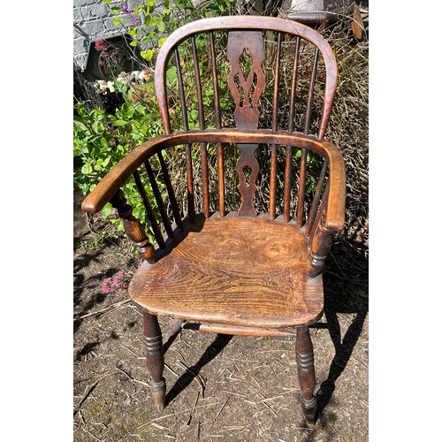 131 - A 19thC ash and elm Windsor armchair. Height to back 96cm.