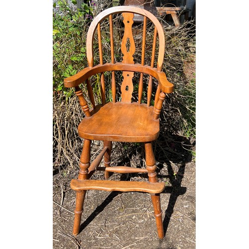 132 - A 20thC child’s Windsor style high chair. Height to back 99cm.