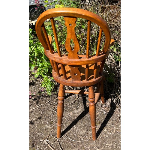 132 - A 20thC child’s Windsor style high chair. Height to back 99cm.