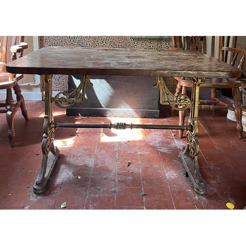 133 - A 19thC pub table with cast iron base. Top 105cm x 72cm 75cm.