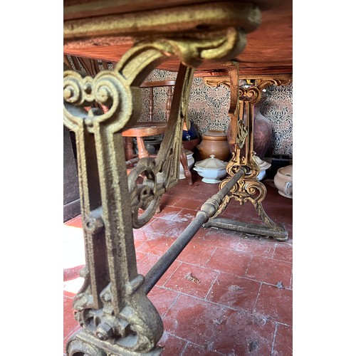 133 - A 19thC pub table with cast iron base. Top 105cm x 72cm 75cm.