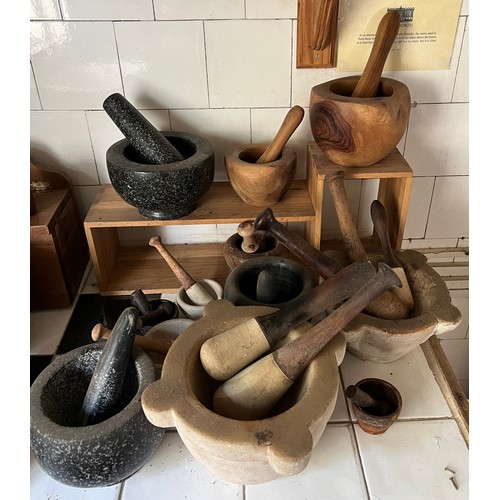 957 - Twelve various pestle and mortars to include ceramic, granite, wood and iron. Extra pestles.