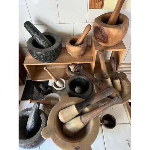 957 - Twelve various pestle and mortars to include ceramic, granite, wood and iron. Extra pestles.