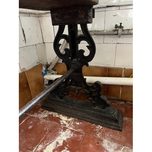 127 - An oblong pub table with cast iron base. 122cm x 50cm x 76cm h.