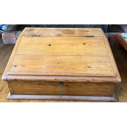 129 - A pine table top desk with sloping lid and fitted interior. 63cm x 49cm x 26cm h.