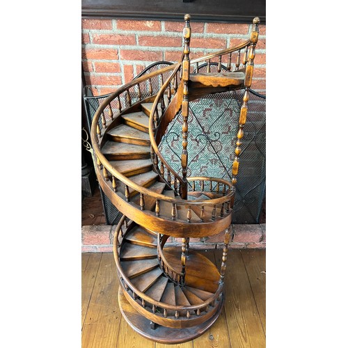 1243 - A miniature spiral staircase with rounded handrail and turned posts. 106cm h.