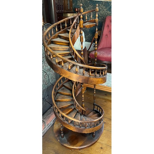 1243 - A miniature spiral staircase with rounded handrail and turned posts. 106cm h.