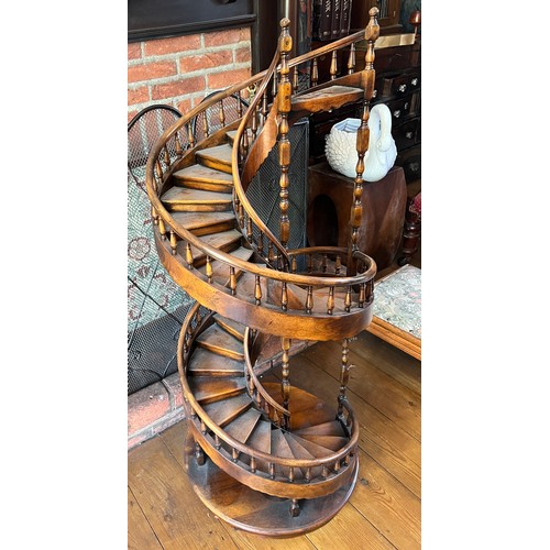 1243 - A miniature spiral staircase with rounded handrail and turned posts. 106cm h.