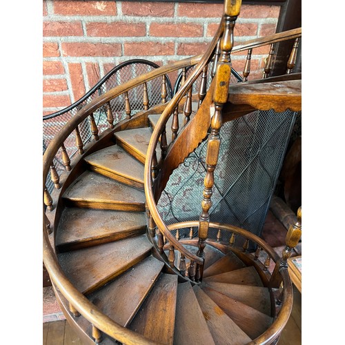 1243 - A miniature spiral staircase with rounded handrail and turned posts. 106cm h.