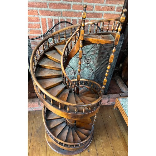 1243 - A miniature spiral staircase with rounded handrail and turned posts. 106cm h.