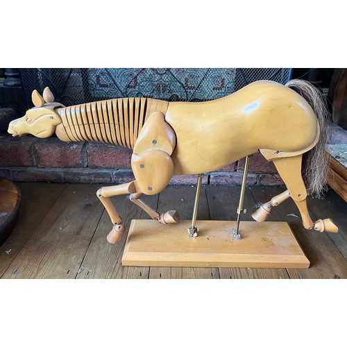 1244 - An artist’s wooden articulated model of a horse. 64cm l x 38cm h.