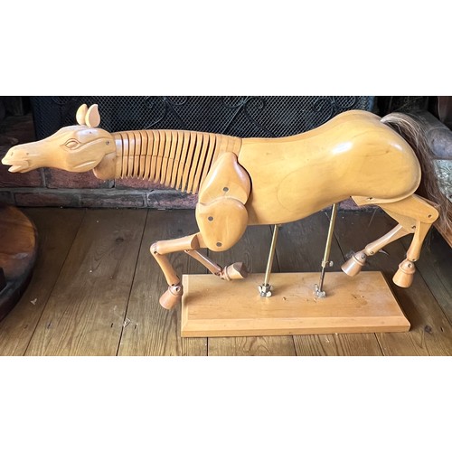 1244 - An artist’s wooden articulated model of a horse. 64cm l x 38cm h.