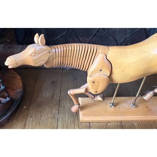 1244 - An artist’s wooden articulated model of a horse. 64cm l x 38cm h.