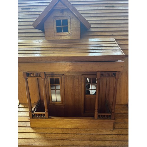 1059 - A large wooden doll’s house and a quantity of furniture etc. 86cm x 56cm x 86cm h.