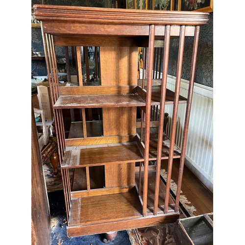 116 - An Edwardian oak revolving bookcase 115cm h x 60cm x 60cm.