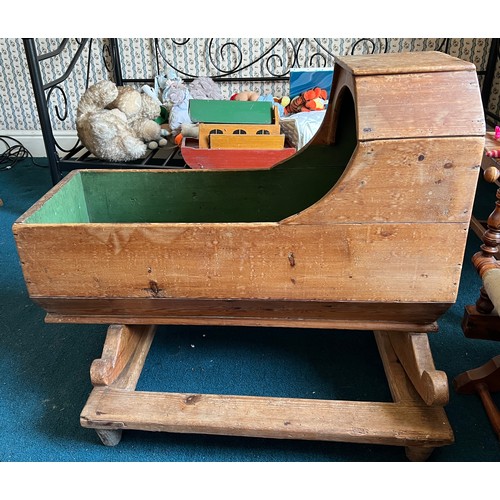 119 - A 19thC pine cradle on rockers on stand. 84cm x 35cm x 75cm.