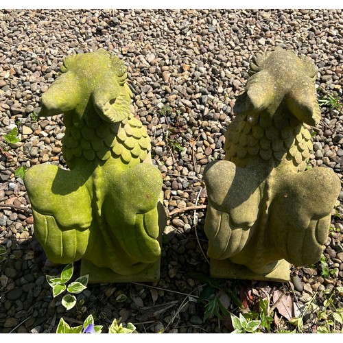 5 - A pair of reconstituted stone griffins. 57cm h.