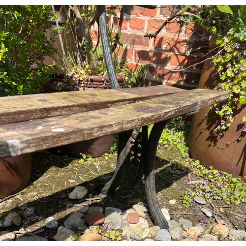 6 - A vintage cast iron and wooden bench. 152cm l x 30cm d.