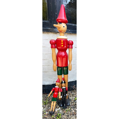 1058 - Three vintage Pinocchio models. Tallest 113cm.