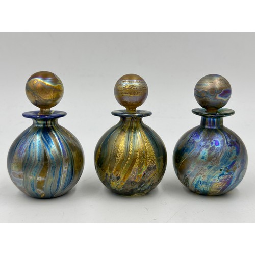 547 - Timothy Harris - Isle of Wight - British Museum.
 Four perfume bottles with stoppers to include 3 x ... 