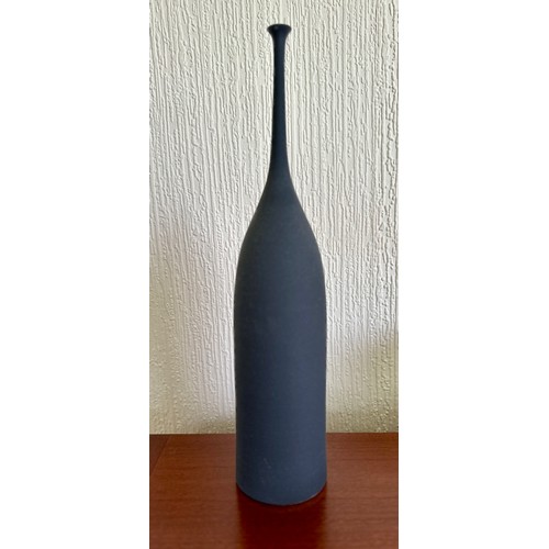 327 - Sophie Cook; a tall narrow necked porcelain bottle covered in dark grey glaze, 'Navy Teardrop' impre... 