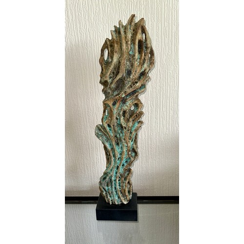 331 - Wendy Lawrence; a carved stoneware sculpture layered with textured volcanic glazes on a stone base, ... 