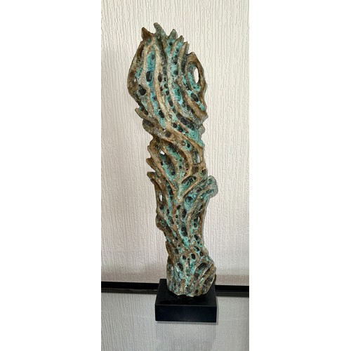 331 - Wendy Lawrence; a carved stoneware sculpture layered with textured volcanic glazes on a stone base, ... 